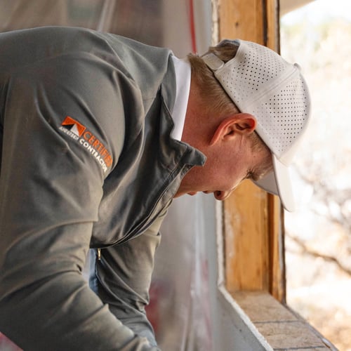 Contractor looking at a rough window opening