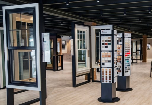 Andersen Windows showroom with black and white double-hung windows and color swatches