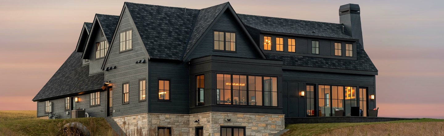 house on a hill with sunset in background